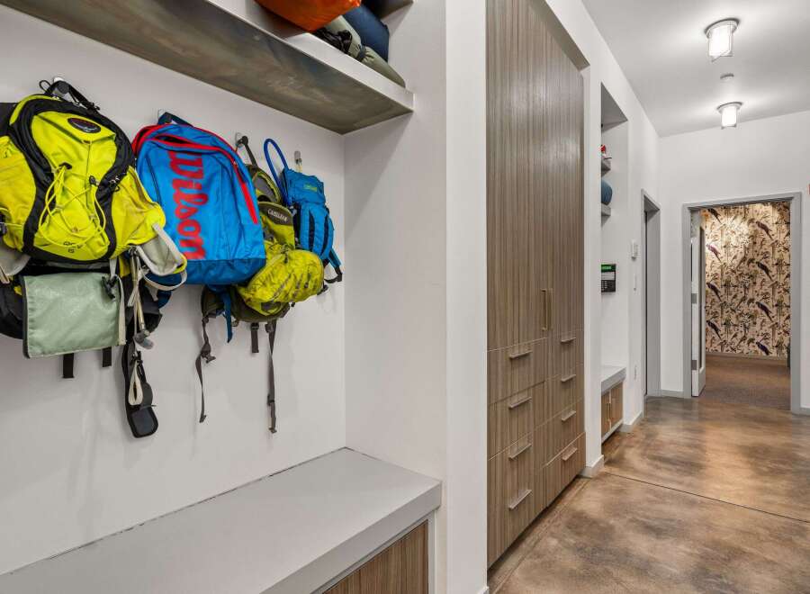 This stunning entryway showcases a modern design with sleek lines and functional storage solutions.