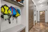 This stunning entryway showcases a modern design with sleek lines and functional storage solutions.