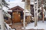 This stunning property boasts a beautiful wooden door and a charming stone facade, creating a warm and inviting atmosphere.