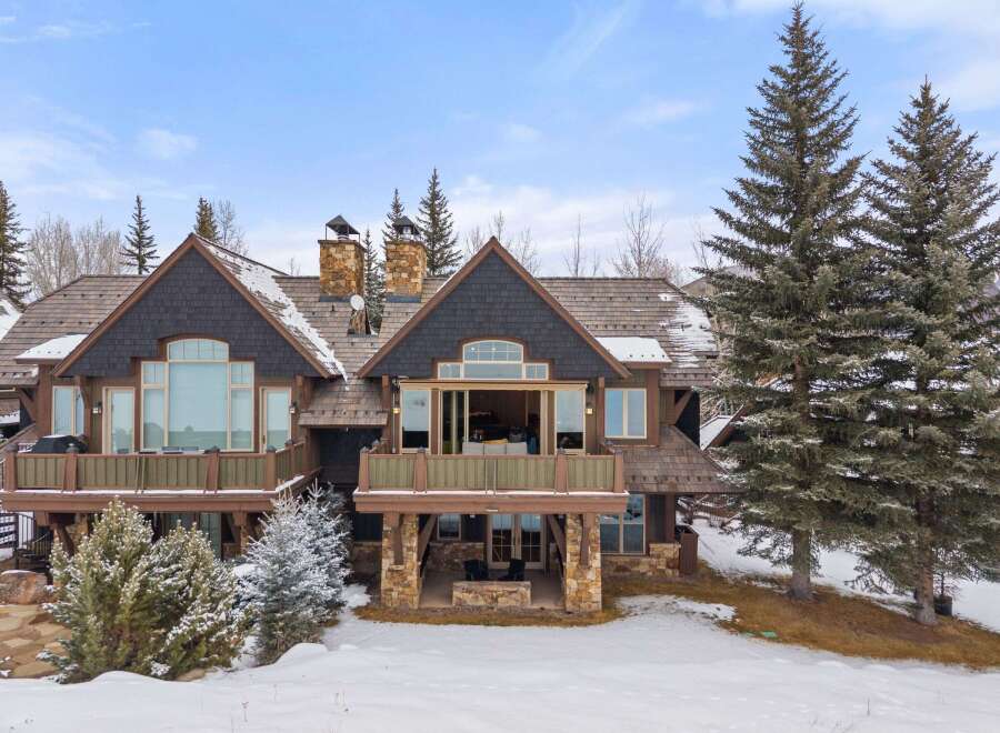 This stunning mountain home boasts a beautiful exterior with a combination of stone and wood accents.