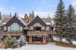 This stunning mountain home boasts a beautiful exterior with a combination of stone and wood accents.