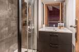 This modern bathroom features a sleek shower enclosure and a stylish vanity.