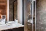 Step into luxury with this stunning bathroom featuring a sleek shower and a modern sink.