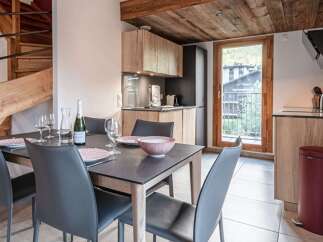 Experience luxury living in this stunning property featuring a modern kitchen and a stylish dining area.