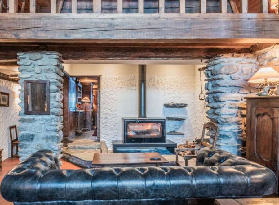 Step into rustic elegance with this stunning property, featuring exposed wooden beams and stone accents that exude warmth and charm.
