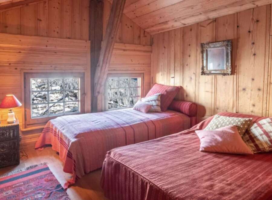 This cozy bedroom features a rustic wooden interior, creating a warm and inviting atmosphere.