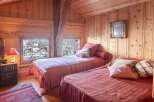 This cozy bedroom features a rustic wooden interior, creating a warm and inviting atmosphere.