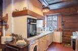 Step into the heart of this charming kitchen, where rustic elegance meets modern convenience.