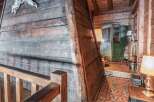 Step into rustic elegance with this stunning property, showcasing exquisite wooden craftsmanship throughout.