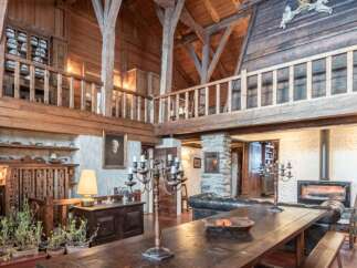 Step into rustic elegance with this stunning property, showcasing a harmonious blend of wood and stone.