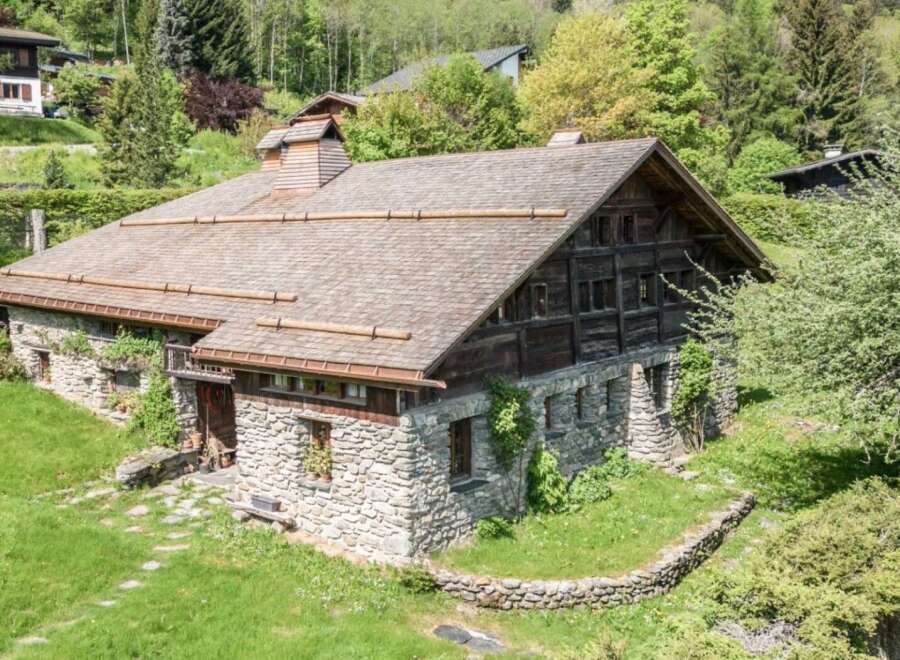 This stunning stone and wood chalet offers a unique blend of rustic charm and modern comfort.