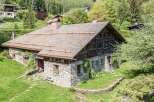 This stunning stone and wood chalet offers a unique blend of rustic charm and modern comfort.