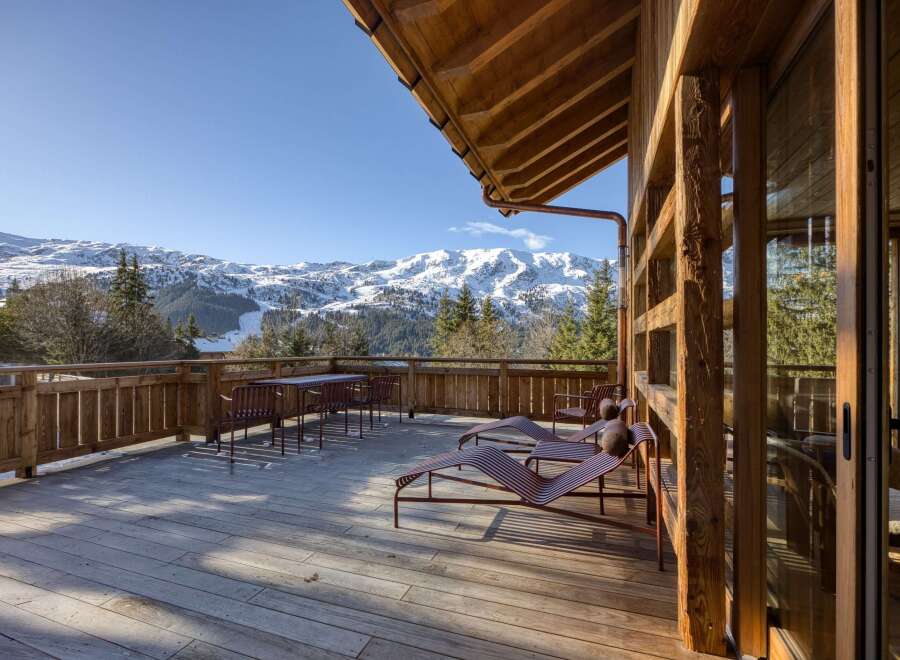 Experience the ultimate in luxury living with this stunning property featuring a spacious deck with breathtaking mountain views.