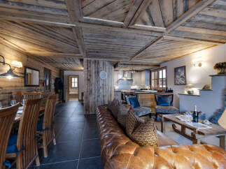 Step into rustic elegance with this stunning property, featuring a beautifully designed interior with exposed wooden beams and paneling.