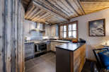 This stunning kitchen boasts a rustic charm with its wooden ceiling and cabinetry.