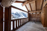 Experience breathtaking mountain views from this charming wooden balcony.