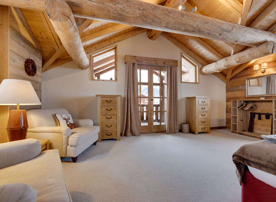 This stunning property boasts a rustic charm with its exposed wooden beams and paneled walls, creating a warm and inviting atmosphere.