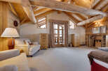 This stunning property boasts a rustic charm with its exposed wooden beams and paneled walls, creating a warm and inviting atmosphere.