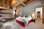 This stunning bedroom features a unique blend of rustic charm and modern comfort.