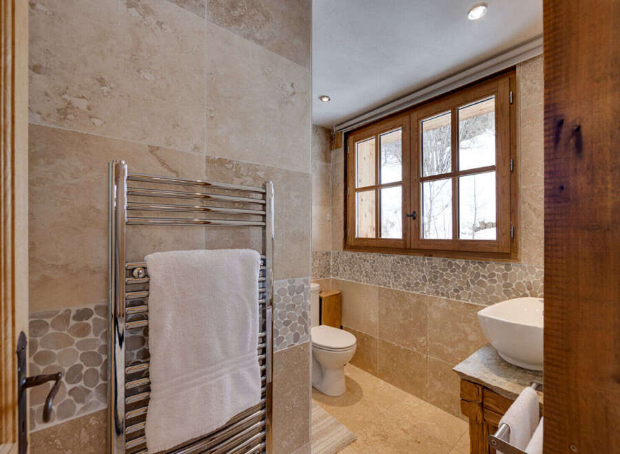 This stunning bathroom showcases a blend of rustic charm and modern elegance.