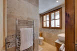 This stunning bathroom showcases a blend of rustic charm and modern elegance.