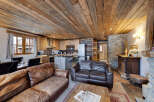 This stunning property boasts a rustic charm with its wooden ceiling and stone accents, creating a warm and inviting atmosphere.