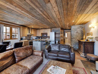 This stunning property boasts a rustic charm with its wooden ceiling and stone accents, creating a warm and inviting atmosphere.