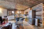 Discover the charm of this rustic kitchen, featuring a unique wooden ceiling and walls that exude warmth and character.