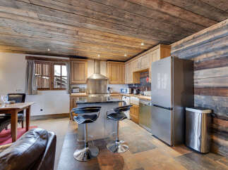 Discover the charm of this rustic kitchen, featuring a unique wooden ceiling and walls that exude warmth and character.