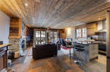 Experience rustic luxury in this stunning chalet, featuring a cozy stone fireplace and exposed wooden beams.