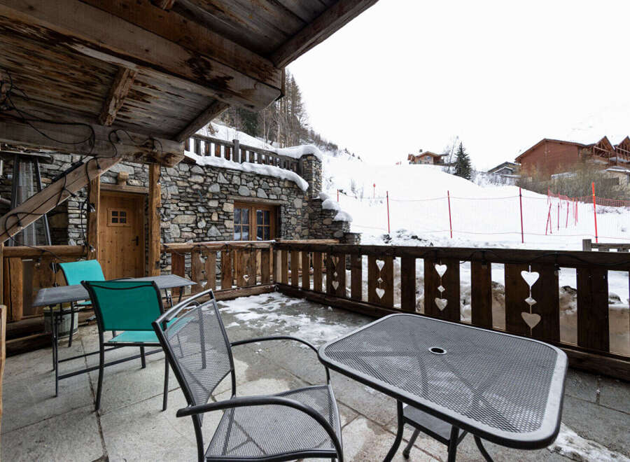 Enjoy breathtaking mountain views from this charming chalet balcony.
