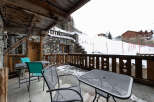 Enjoy breathtaking mountain views from this charming chalet balcony.