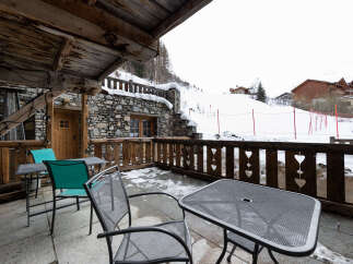 Enjoy breathtaking mountain views from this charming chalet balcony.
