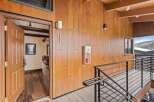 This stunning property boasts a modern design with beautiful wood paneling and a sleek staircase.