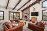 Experience luxury living in this stunning property, featuring a cozy living room with a stone fireplace, perfect for chilly evenings.