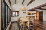 Step into rustic elegance with this stunning dining room! Featuring a unique antler chandelier, a custom wooden dining table, and log-style chairs, this space exudes warmth and charm.