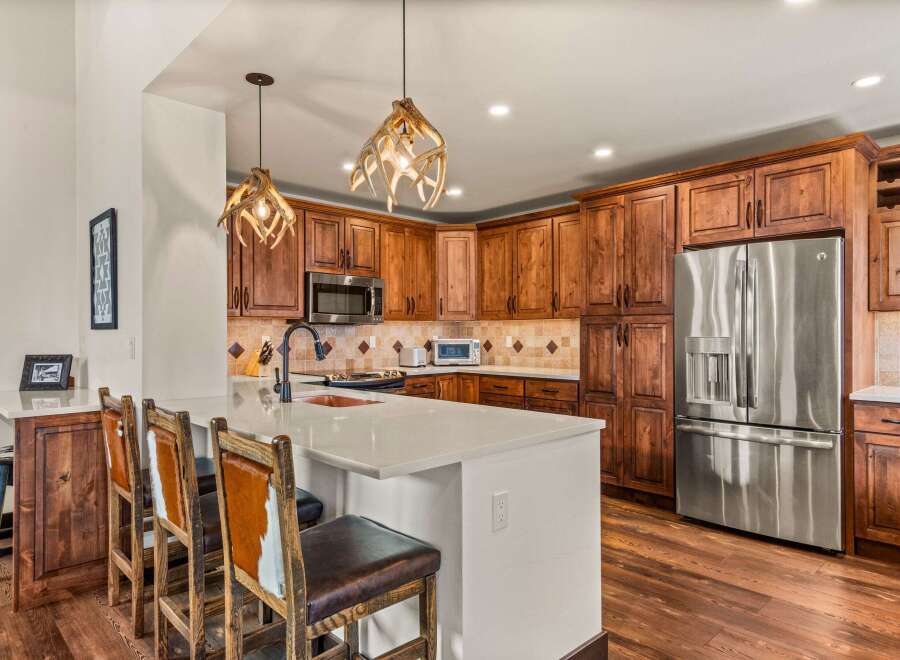 This stunning kitchen boasts custom cabinetry and a spacious layout, perfect for both cooking and entertaining.