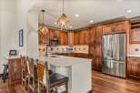 This stunning kitchen boasts custom cabinetry and a spacious layout, perfect for both cooking and entertaining.