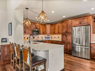 This stunning kitchen boasts custom cabinetry and a spacious layout, perfect for both cooking and entertaining.