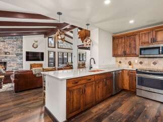 This stunning kitchen boasts rustic charm with its wooden cabinetry and island.