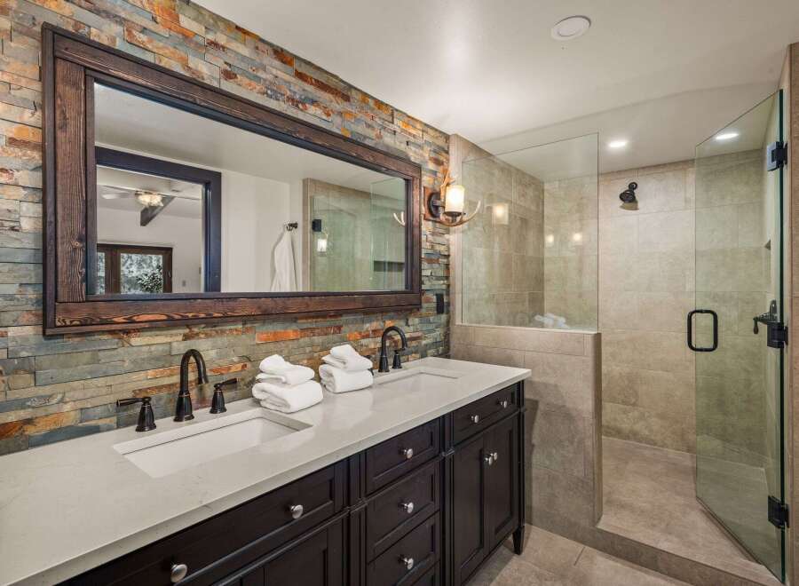This stunning bathroom boasts a rustic, yet modern design, perfect for a luxurious retreat.