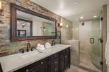 This stunning bathroom boasts a rustic, yet modern design, perfect for a luxurious retreat.
