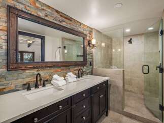 This stunning bathroom boasts a rustic, yet modern design, perfect for a luxurious retreat.