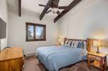 This cozy bedroom features a rustic design with wooden accents and a serene atmosphere.