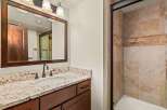 This stunning bathroom features a beautiful granite countertop and a stylish vanity with ample storage.