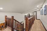 This stunning property features a rustic staircase with a unique log railing, adding a touch of natural elegance.