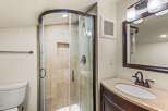 Step into this beautifully designed bathroom featuring a modern glass shower enclosure.