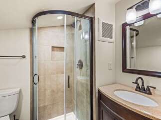 Step into this beautifully designed bathroom featuring a modern glass shower enclosure.