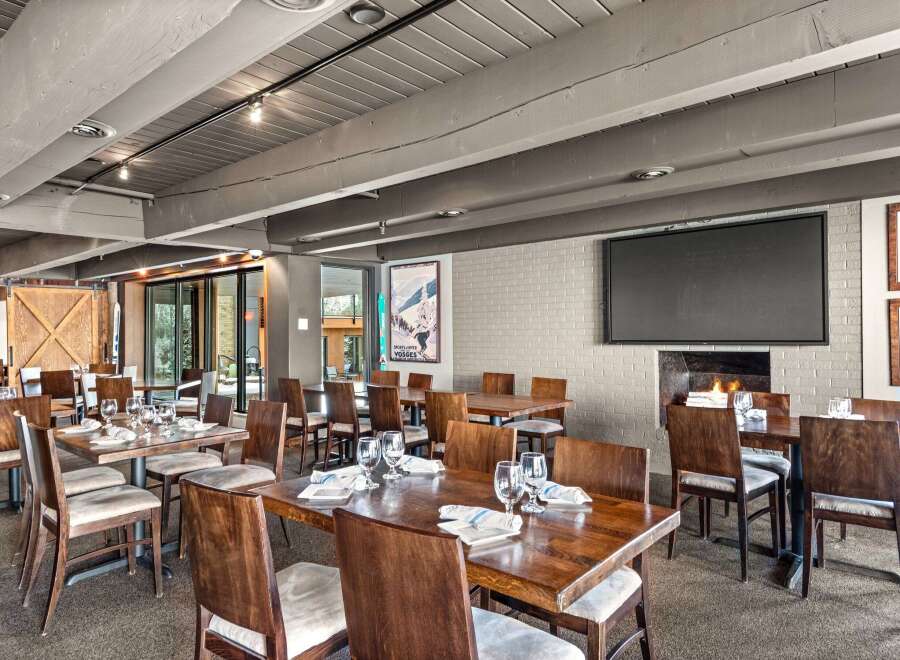 This inviting restaurant space features a warm, rustic ambiance, perfect for a memorable dining experience.