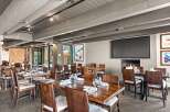 This inviting restaurant space features a warm, rustic ambiance, perfect for a memorable dining experience.